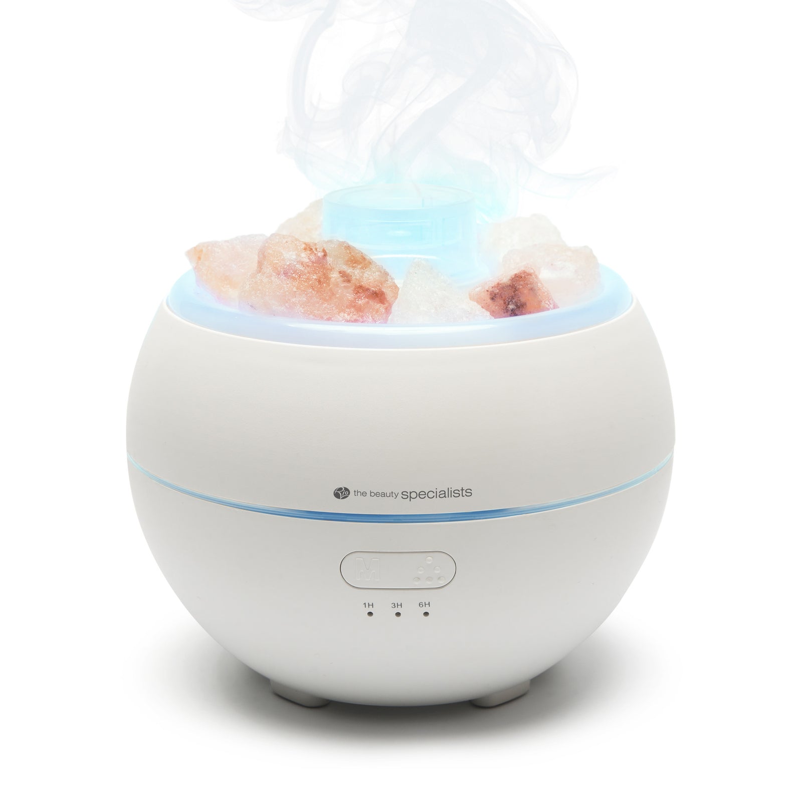 The Rio Aroma Diffuser, Humidifier & Night-Light with Himalayan Rock Salt is a round white device that emits mist from the top, features pink salt rocks inside, and has a front control panel with indicator lights.
