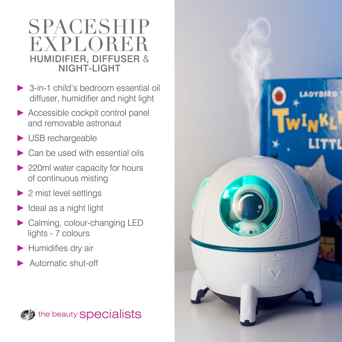 The Rio Spaceship Explorer Child’s Essential Oil Diffuser, Humidifier, and Night Light emits mist with a glowing green light. It sits on a table near the children’s book “Twinkle Little Star,” with highlighted features.