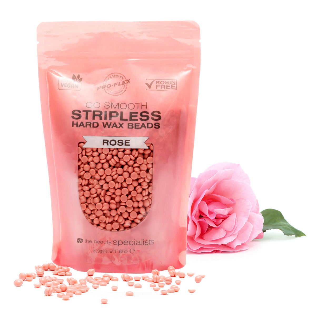 A pink pouch of Rio Rose Go Smooth Stripless Hard Wax Beads (500g) stands upright, with small pink wax beads and a rose beside it on a white background, promising smooth skin.