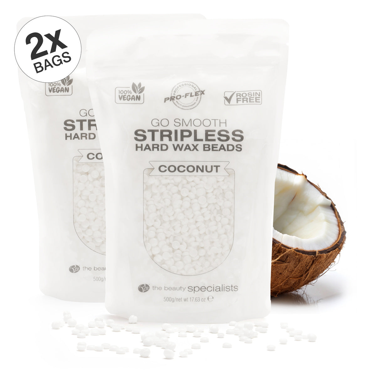 Two white resealable Rio Coconut Go Smooth Stripless Hard Wax Beads (500g) bags stand side by side, surrounded by scattered wax beads and a halved coconut. A 2x Bags label highlights smooth skin results with this stripless wax.