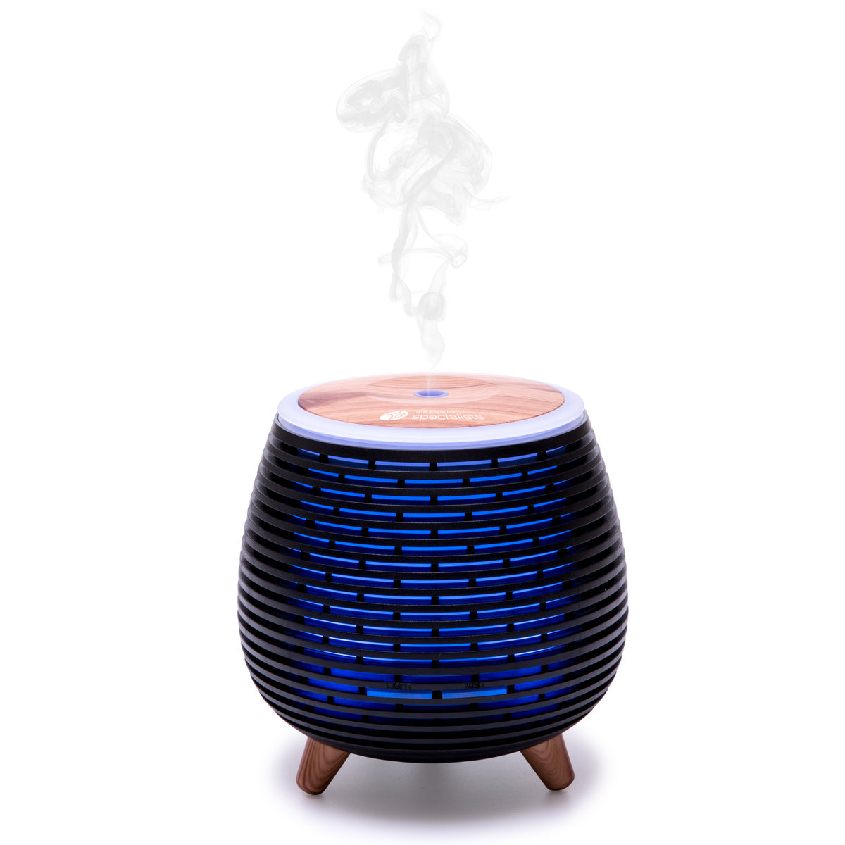 The Rio ZOEY Aroma Diffuser, Humidifier & Night-Light features a modern round design with a wood top, glowing blue lines, and short wooden legs. It releases a gentle white mist to create a calm and peaceful atmosphere in your space.