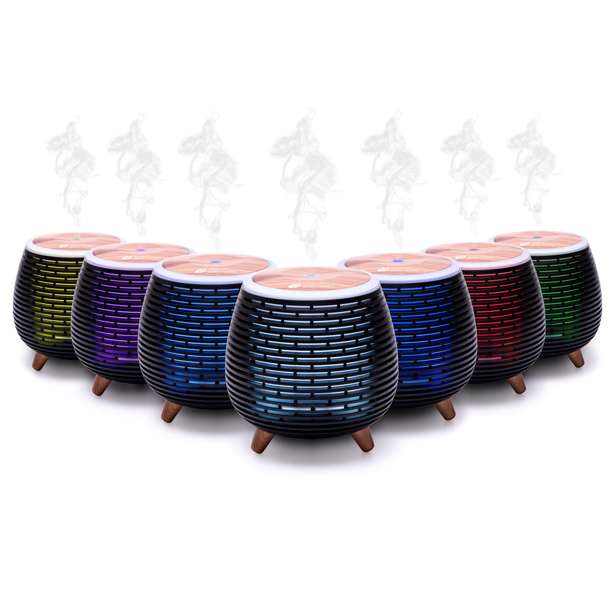 Seven Rio ZOEY Aroma Diffuser, Humidifier & Night-Light units with wooden tops and black bases, each glowing in a different color and releasing vapor, are lined up to create a calming atmosphere ideal for relaxation.