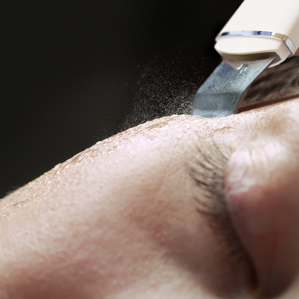A close-up of a person receiving a gentle exfoliation treatment near the eye with the Rio Ultrasonic Skin Cleanser, effectively removing impurities.