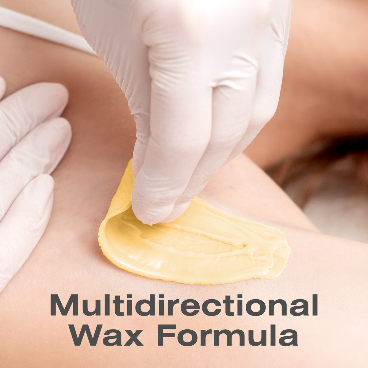 A gloved hand peels off Rio Honey Go Smooth Stripless Hard Wax Beads (100g) from skin, revealing smooth results. The text Multidirectional Wax Formula is displayed at the bottom of the image.