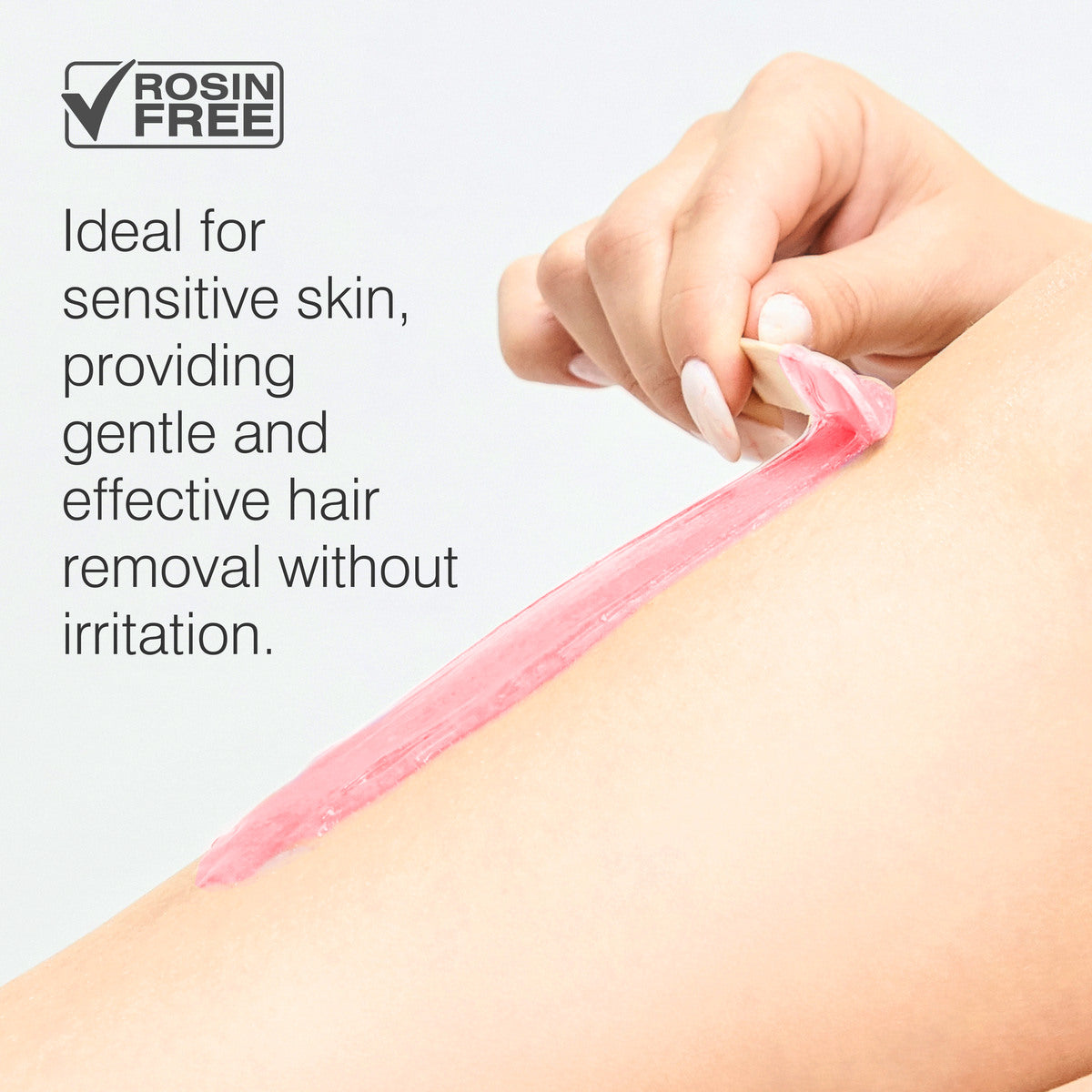A hand peels off a strip of pink wax from smooth skin. Text reads: “Rio Rose Go Smooth Stripless Hard Wax Beads—rosin free and gentle for sensitive skin, providing effective hair removal with no irritation.”.