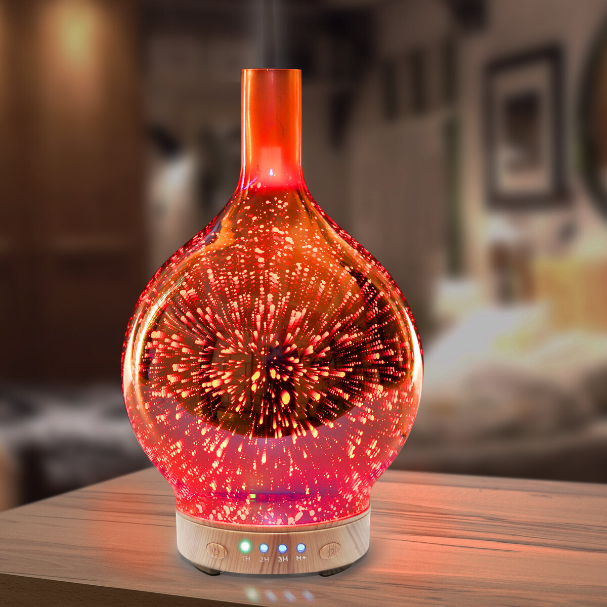 The Rio ELLA Aroma Diffuser, Humidifier, and Night-Light features a glowing glass design with a colorful starburst pattern, filling the softly lit bedroom with soothing mist from a wooden table.
