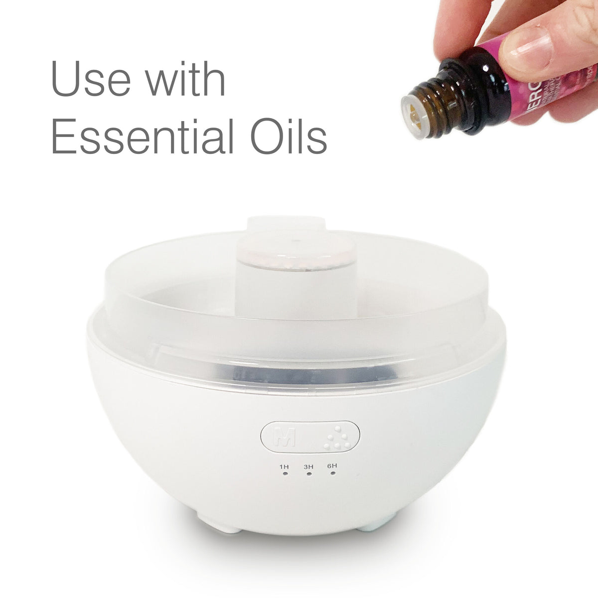 A hand holds a small essential oil bottle above the Rio Aroma Diffuser, Humidifier & Night-Light with Himalayan Rock Salt, highlighting its use with essential oils and its multifunctional benefits.
