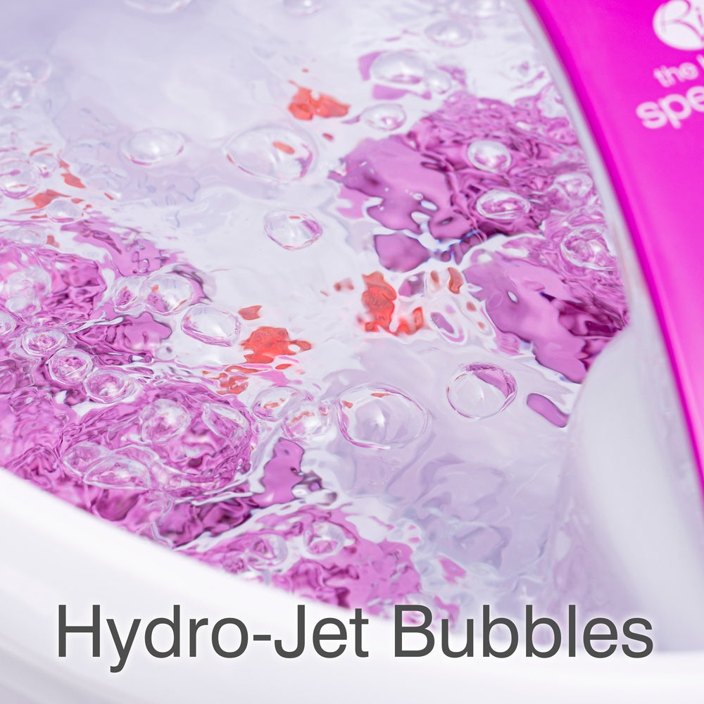 Close-up of bubbling water in the Rio Deluxe Foot Spa Bath and Massager - Purple, with rising hydro-jet bubbles and shimmering reflections. Text at the bottom reads "Hydro-Jet Bubbles.