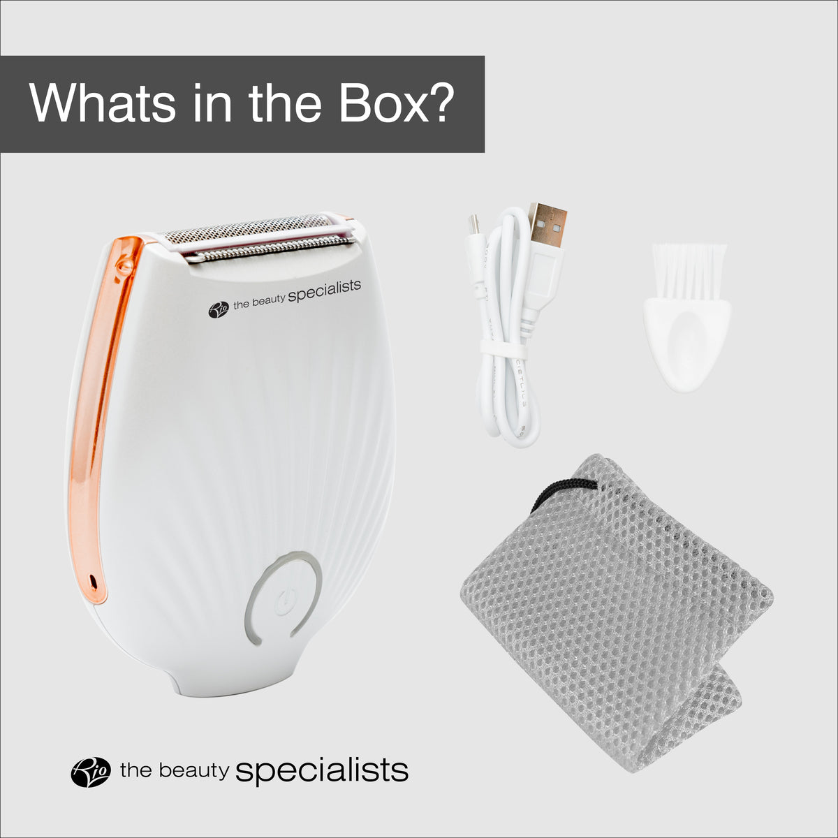The Rio GO SMOOTH Lady Shaver in white with rose gold accents includes a USB charging cable, cleaning brush, and gray textured pouch. “What’s in the Box?” and “the beauty specialists” logo shown—your go-to for effortless shaving.