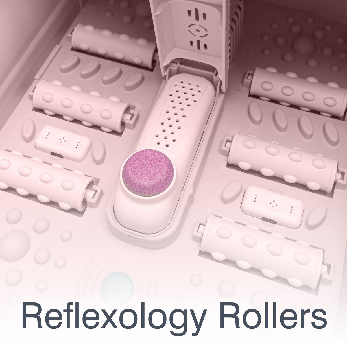 Close-up of reflexology rollers and pumice stone in foot spa for deep tissue massage and exfoliation.