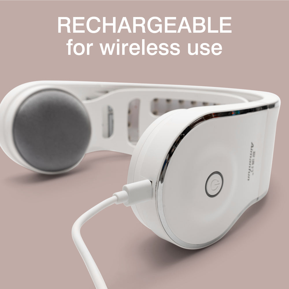 White Rio HairGrow Laser Head Band being charged with a USB cable on a light pink background. Text above reads: "RECHARGEABLE for wireless use—perfect to pair with your red light therapy or hair regrowth routine.