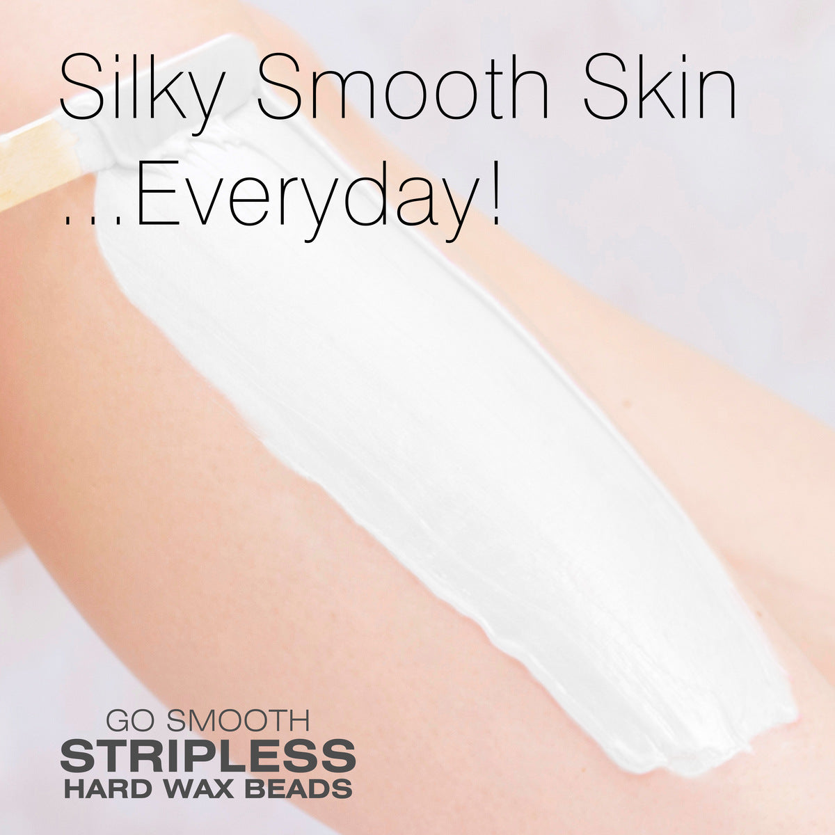 A close-up of a persons arm with a thick layer of white wax being applied. The text reads, Silky Smooth Skin ...Everyday! Rio Coconut Go Smooth Stripless Hard Wax Beads (100g).