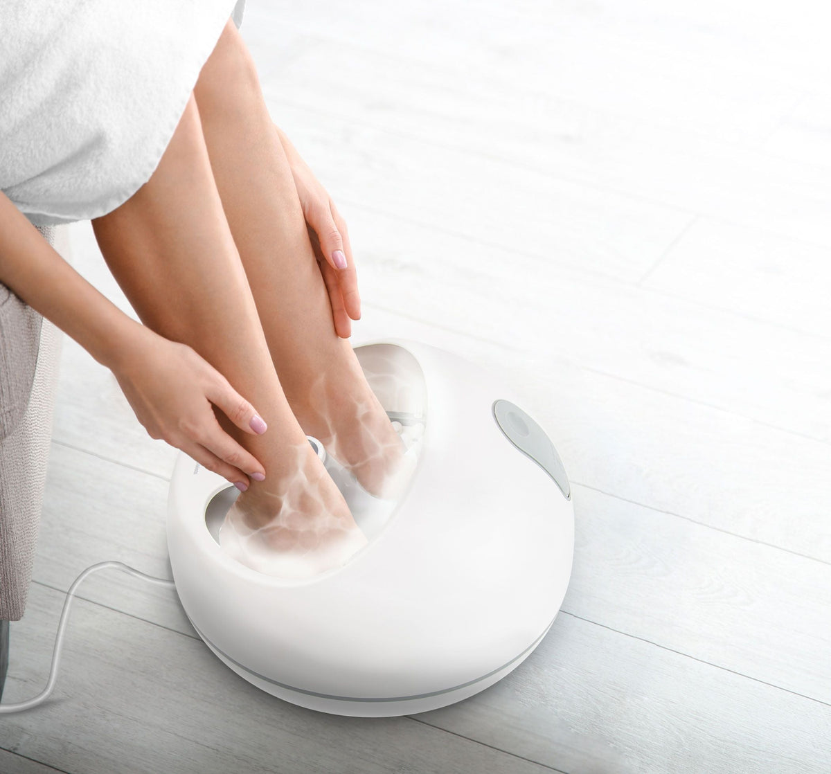 birdseye view of ladies feet inside steam foot spa with steam rising up 