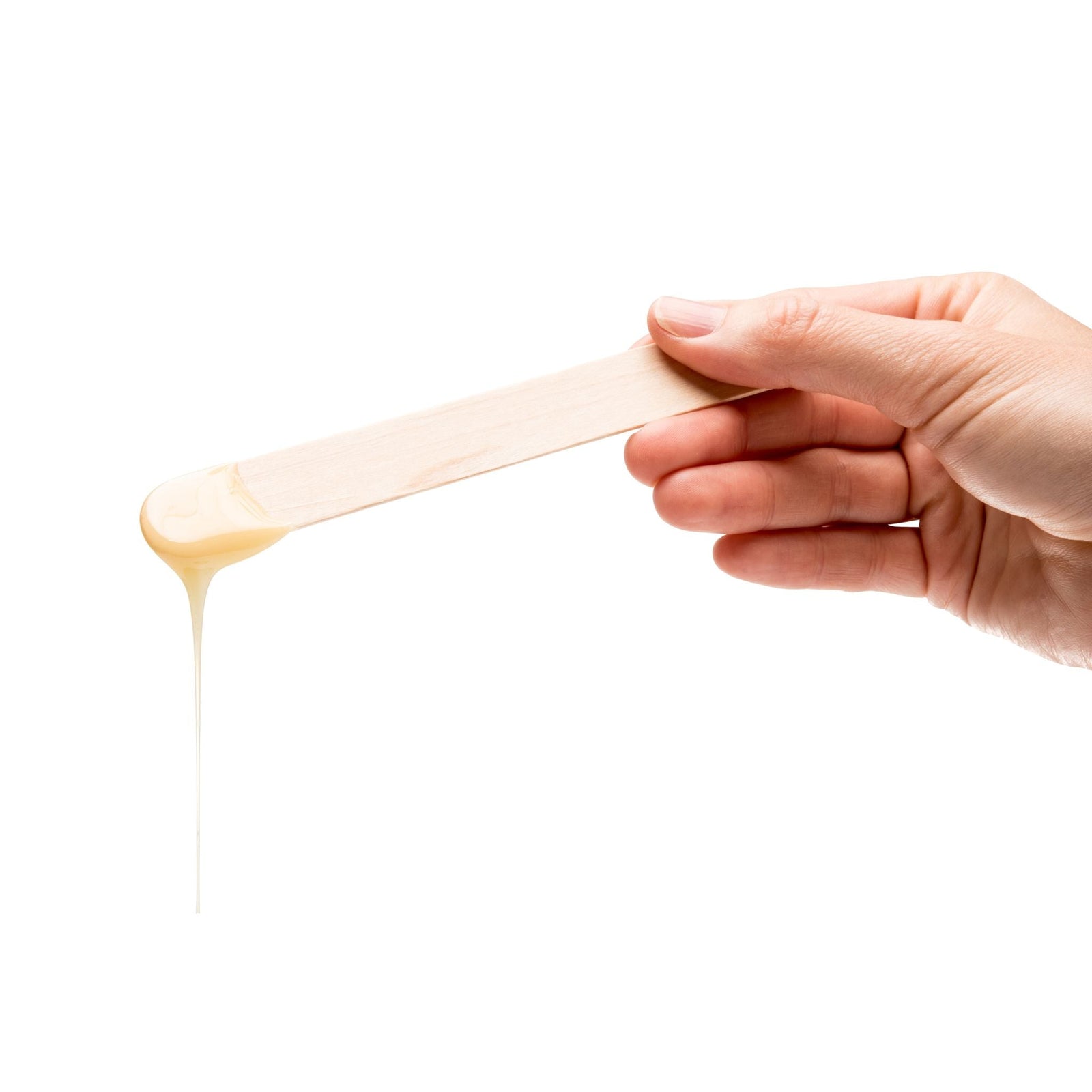 hand holding a spatula with melted wax dripping from it